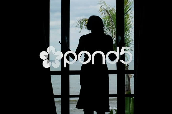 040725133-woman-unveil-curtains-walking-